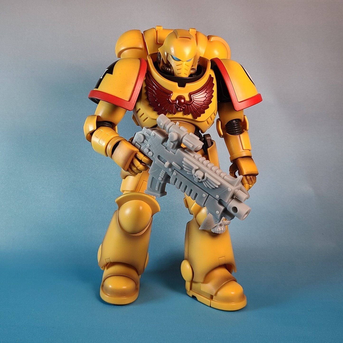 Bandai Warhammer 40,000 Imperials Fists Intercessor Space Marine holding a Fantasy World Games Boltgun with Scope