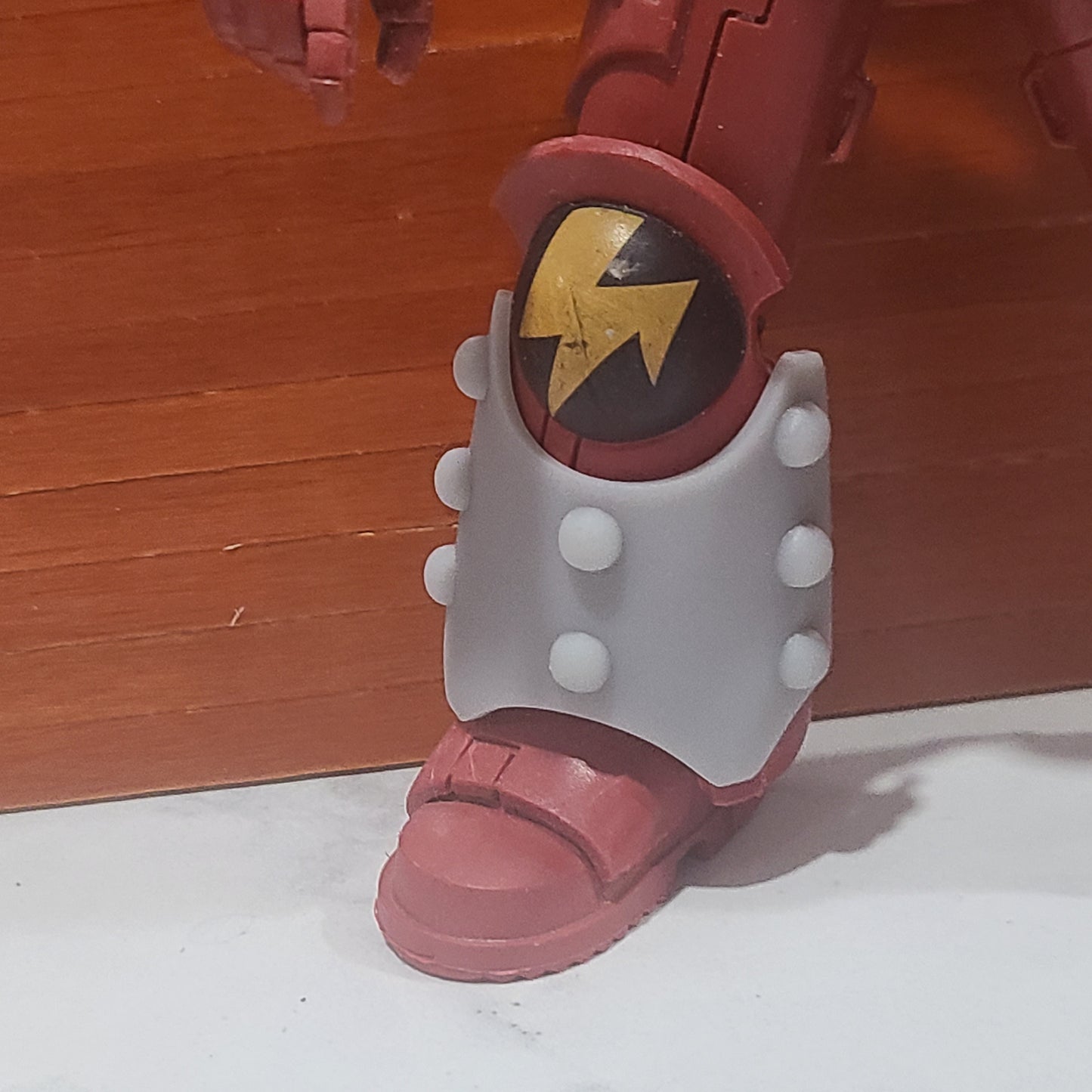 One Custom Shin Guard Armor Decal with Molecular Bonding Studs on a Blood Angels