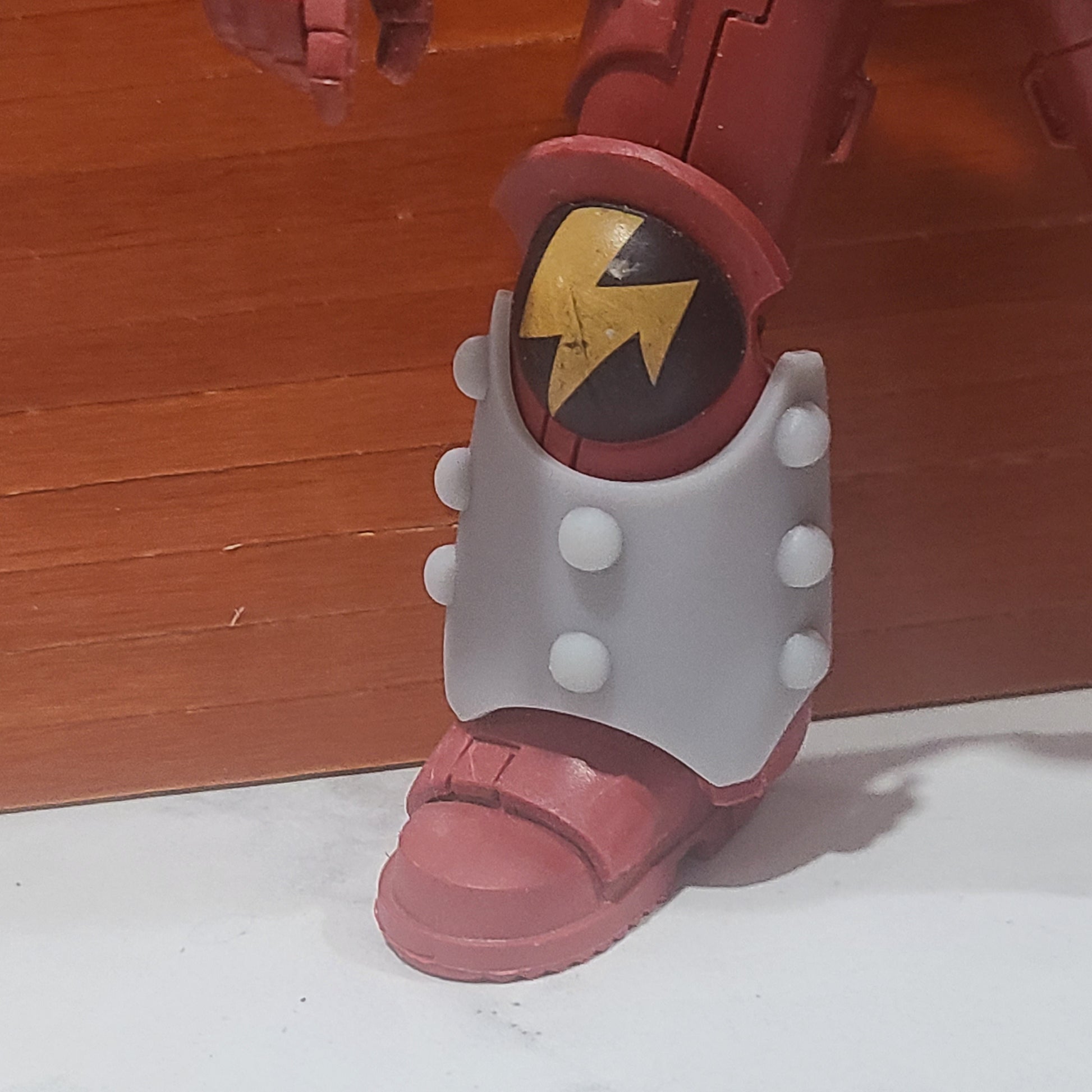 One Custom Shin Guard Armor Decal with Molecular Bonding Studs on a Blood Angels