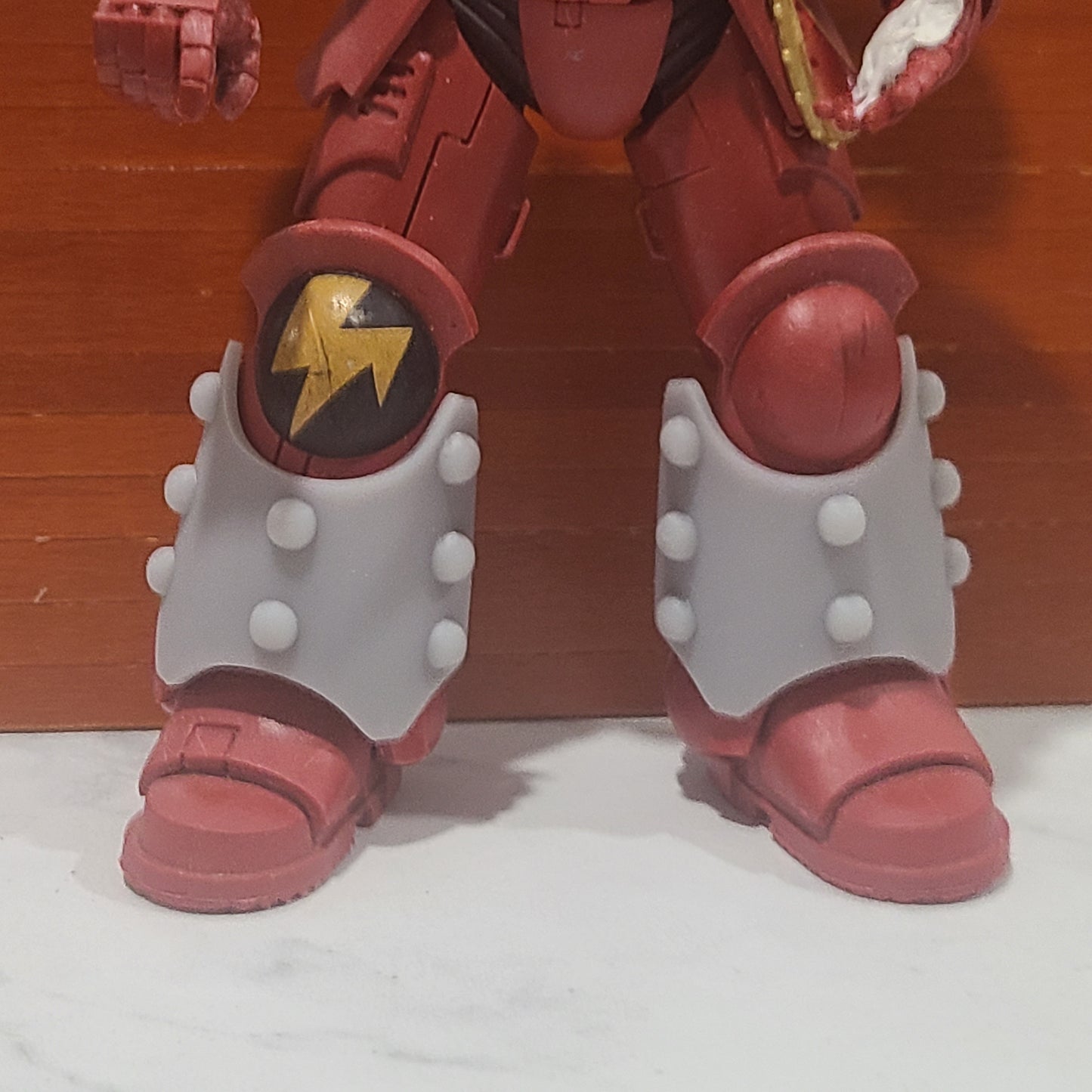 Custom Shin Guard Armor Decals with Molecular Bonding Studs on a Blood Angels