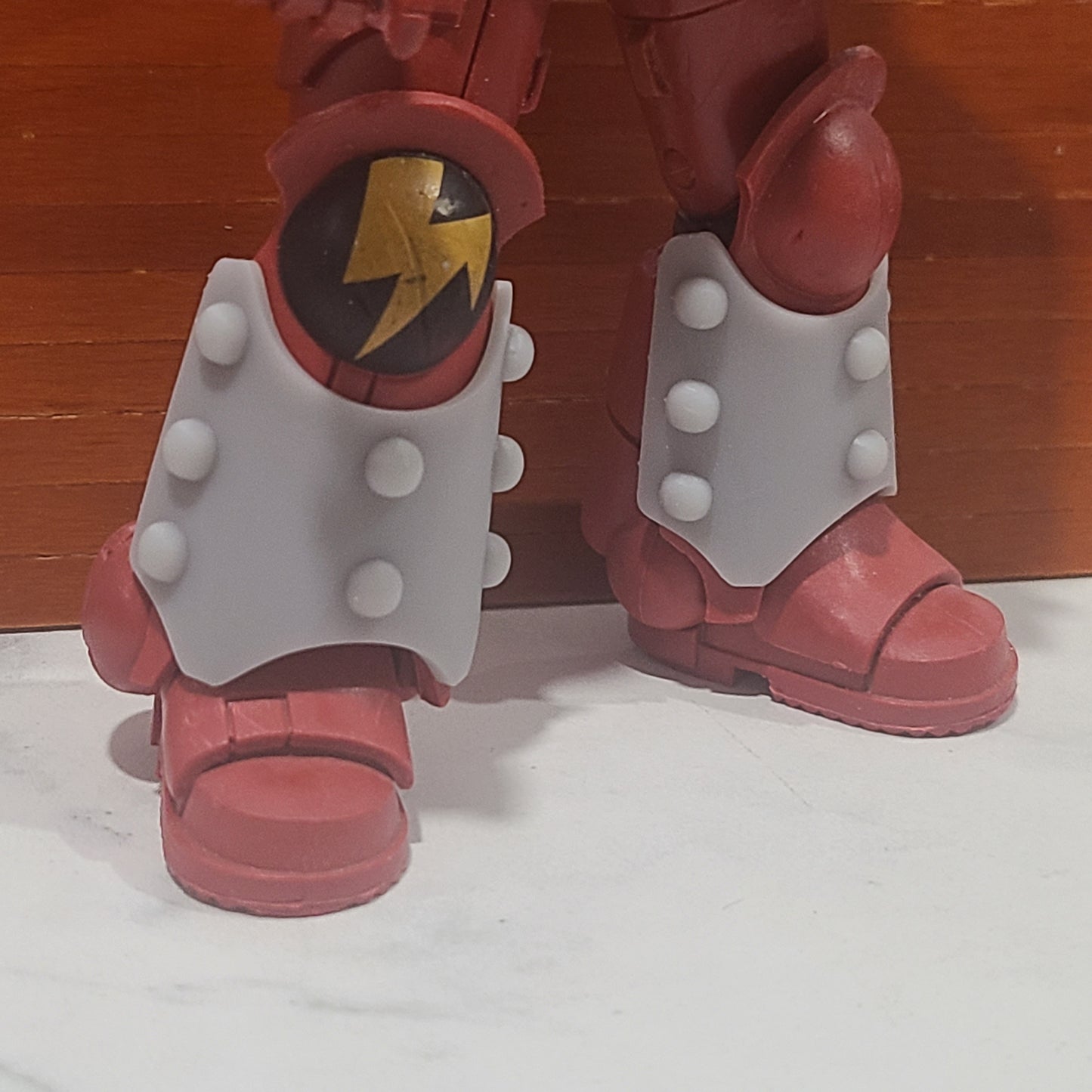 Shin Guard Armor Decal with Molecular Bonding Studs on a Blood Angels Angle