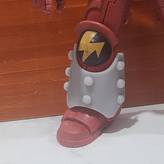 One Custom Shin Guard Armor Decal with Molecular Bonding Studs on a Blood Angels
