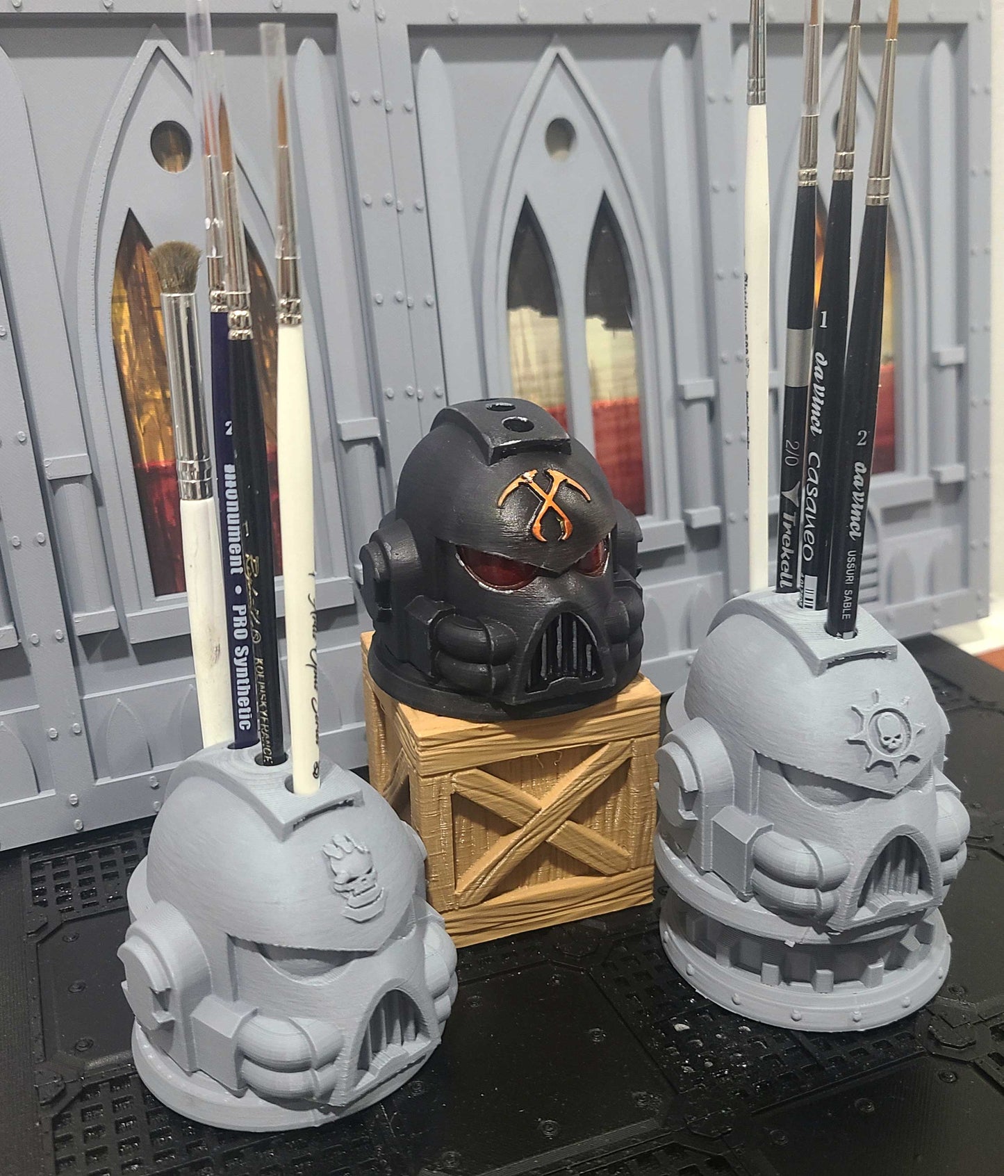 Various G:7 Helmet PLA 3D printed paint brush holder with four openings for miniature painting brushes and hobby tools.