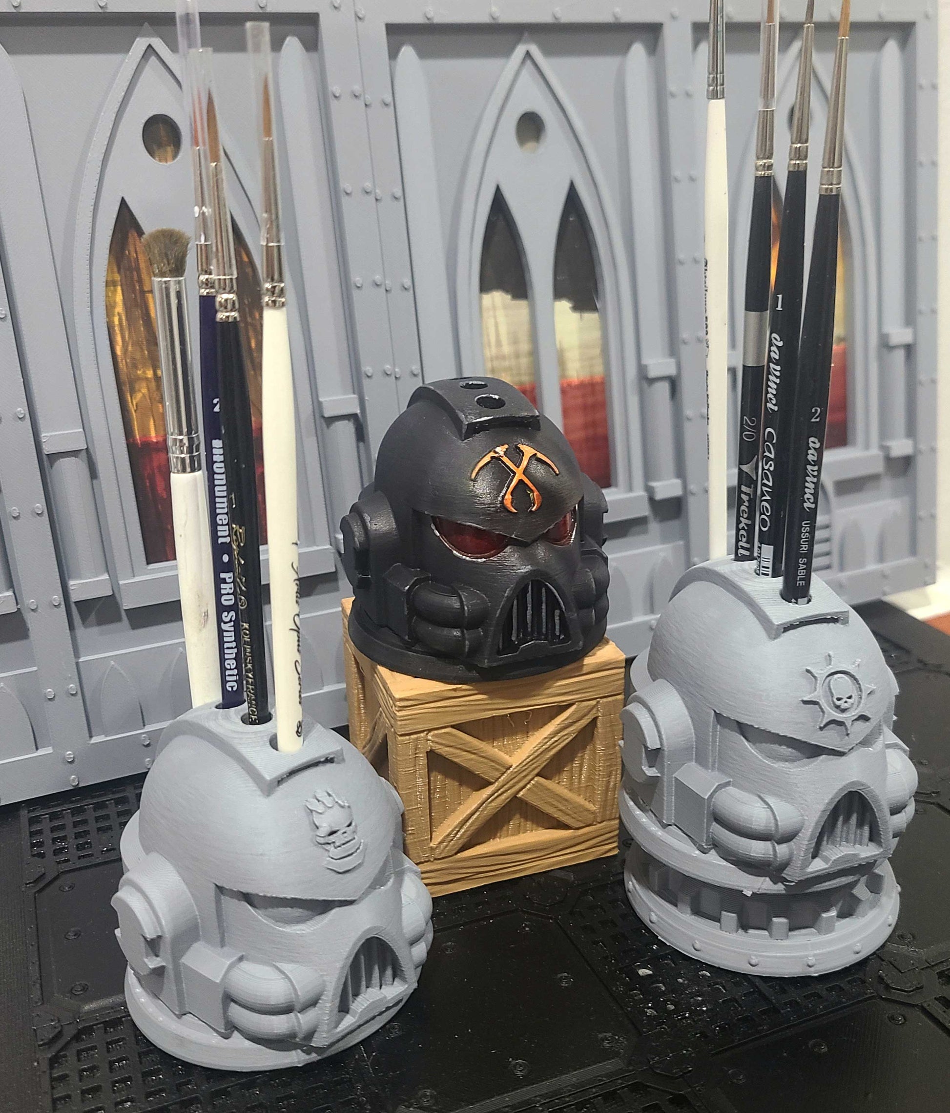 Various G:7 Helmet PLA 3D printed paint brush holder with four openings for miniature painting brushes and hobby tools.